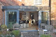 300 year old, Grade 2 listed dwelling adds a stunning contemporary twist with Curved Patio Doors supplied by Balcony Systems. 