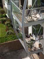 curved steel balcony structure with royal chrome balustrades
