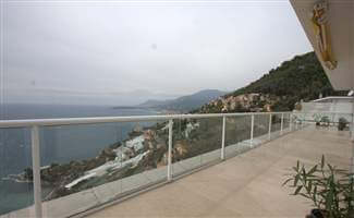 White balustrade with beautiful views down the mountain to the sea