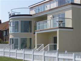 Recidency on the coast with Silver balustrades with a white picket fence