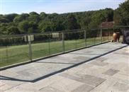 Glass was the balustrading material of choice for this large renovated patio at an East Sussex home that enjoys spectacular unspoilt views across adjoining countryside.