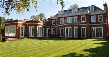 Curved balcony and straight balcony on a beautiful house set in lovely grounds