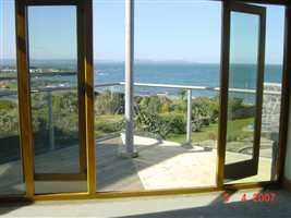 Looking out over the sea through clear glass, white balustrade