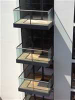Balconies with tinted glass and Royal Chrome handrails