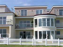 Silver balustrading and Juliet balcony on recidence with white picket fence