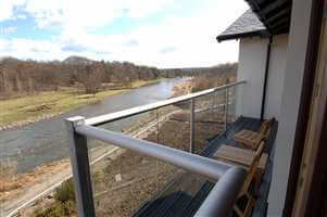 Close up view of the silver handrails with the river and countryside in the distance