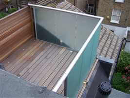 Small box balcony with silver handrails and tinted glass