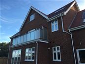 Surrey-based Woldingham Homes have built five luxury detached houses with Glass Balustrades supplied and installed by Balconette.