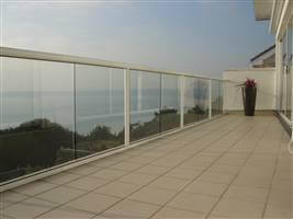 White balustrading to match a beautiful white house on the mountains
