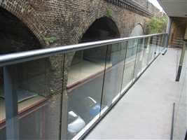 Large balustrade with Royal Chrome handrail over looking brick arches