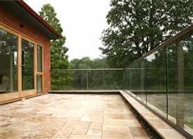 Bronze clear glass balcony surrounded by trees