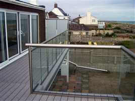 Royal Chrome balustrade with frosted glass privacy screens by the coast