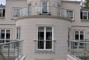 Silver balustrading and Juliet balcony on large beautiful white house