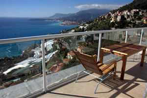 White balustrade looking down on the beautiful mountains and coast