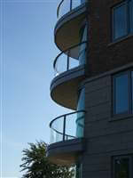 Curved balconies with Silver handrails in the sunset