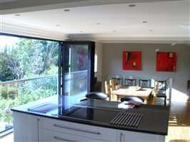 First floor kitchen with folding glass doors and wide Juliet balcony with Royal Chrome handrail