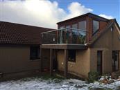 From wooden slats to glass, a clear glass post-less balcony supplied by Balconette has opened up extensive views to the surrounding coastal areas and sea from this property near Aberdeen in North East Scotland.