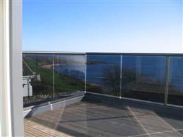 Bronze Balcony 2 with tinted glass by the coast