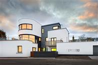 Stunning curved sliding patio doors and windows take advantage of panoramic sea views at Art Deco seafront house at East Lothian on the north-east Scottish coast.