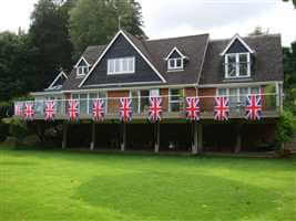 Royal Chrome balustrade across the back of a house with Union Jack flags