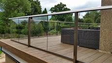 Glass Balcony Balustrade refurbishment and new composite decking in a house in Reigate, Surrey by Balcony Systems. Self cleaning glass balustrades for terrace and stairs.