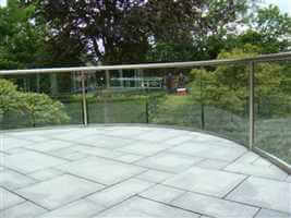 Wide curved balustrade with Royal Chrome handrails and beautiful garden views