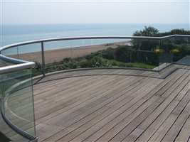 Curved balcony 1 silver balustrade with the view of the beach and the sea with blue sky