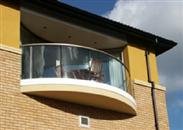 Luxury apartments in Streatham, London make a distinctive architectural statement with Balcony's Curved Clear Glass Balconies.