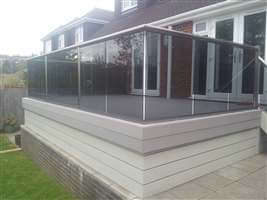 Tinted glass balcony with Royal Chrome handrails and Composite Decking