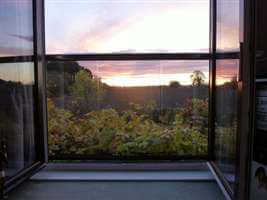 Sunset view through a Juliet balcony with Royal Chrome handrail