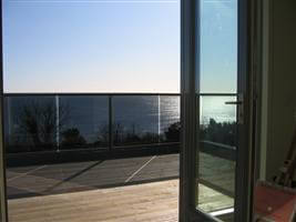 Beautiful views of the coast from a bronze balcony with grey tinted glass