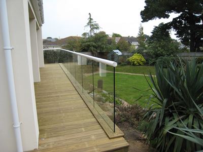 The end of a White Orbit Glass Balustrade installed in a garden