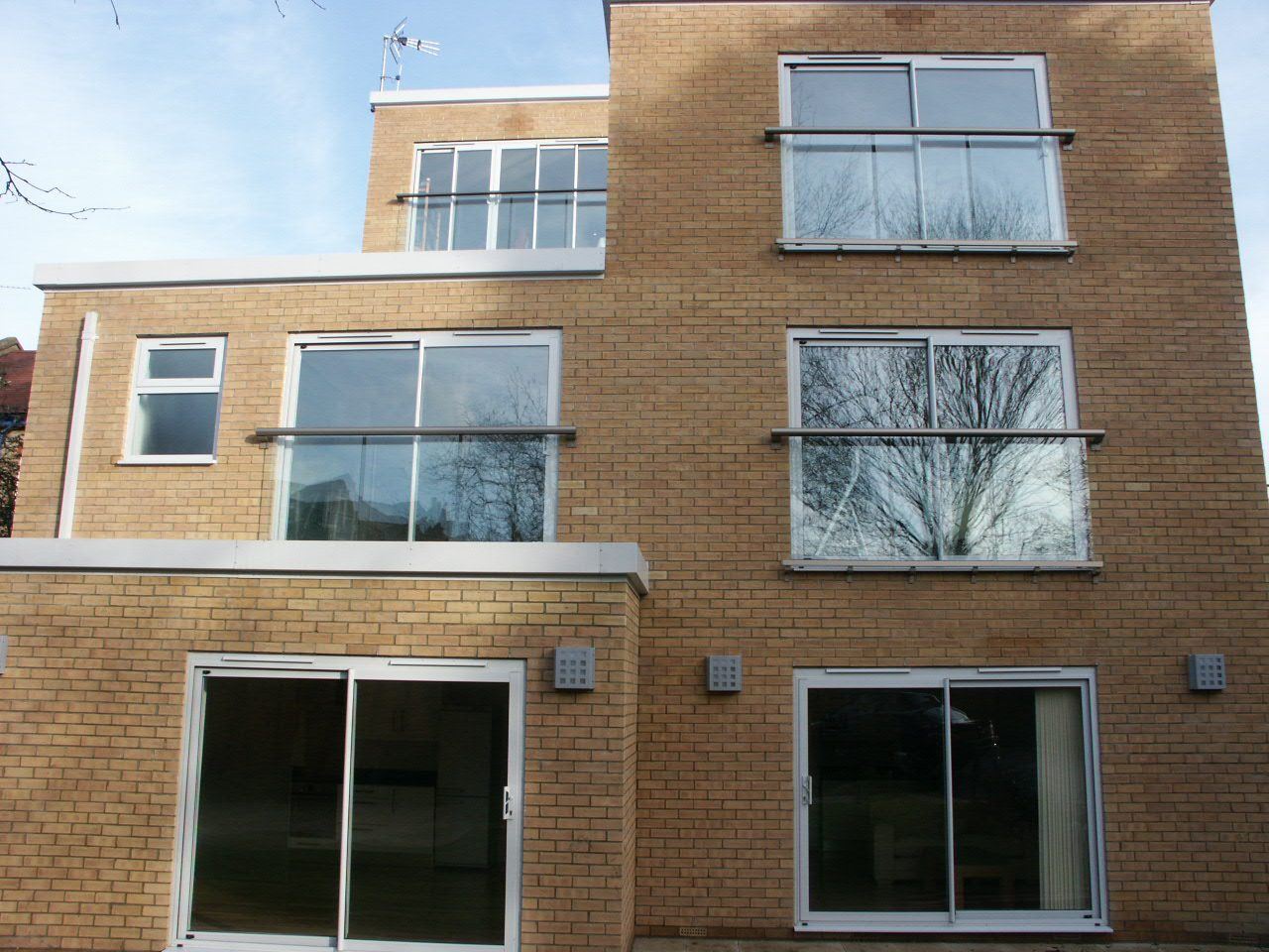 Multiple Juliet balconies installed on a brick property