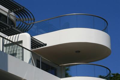 Curved Semi-Frameless Royal Chrome Glass Balustrading surrounded by blue skies.