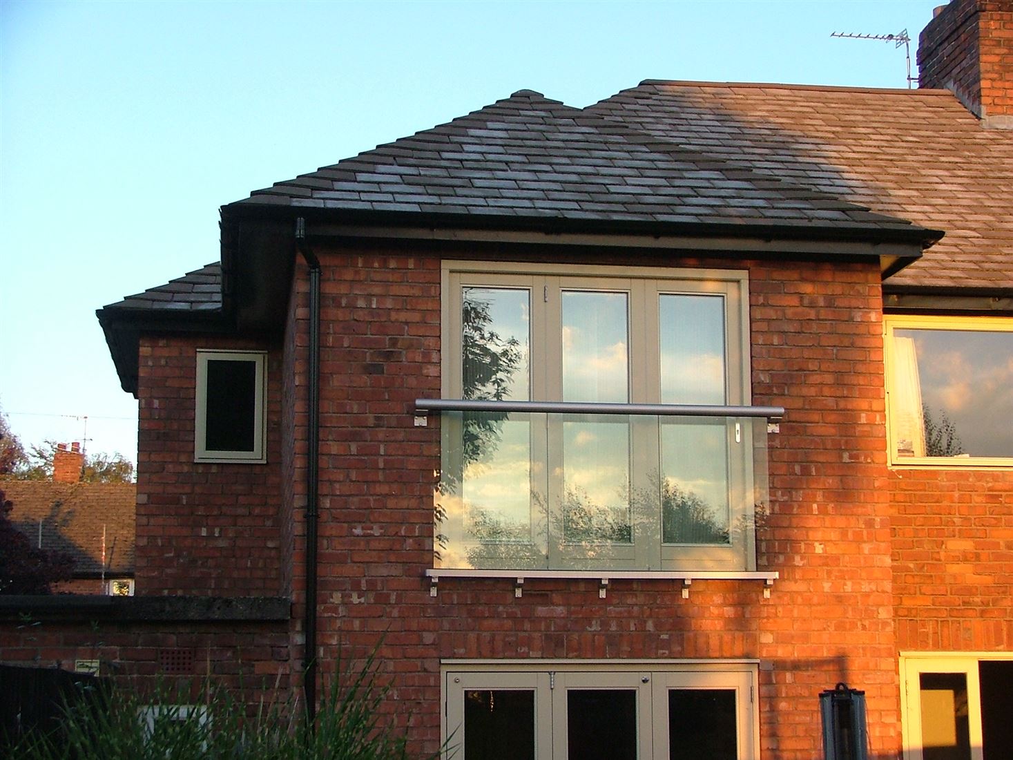 Glass Juliet Balcony installed on a brick house