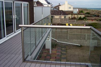 Royal Chrome balustrade with frosted glass privacy screens by the coast