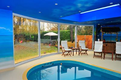 Curved Glass Doors installed in a pool room