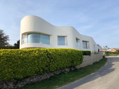Modern unique shaped building with a curved Frameless Glass Balustrade