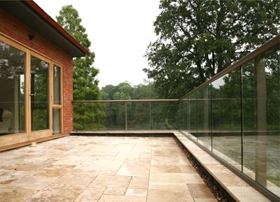 Bronze Aerofoil Glass Balustrade surrounded by trees