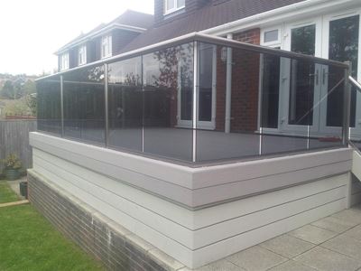 Tinted glass balcony with Royal Chrome handrails and Composite Decking