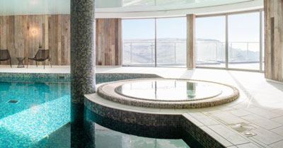 Curved Glass Doors installed in a beautiful pool room 